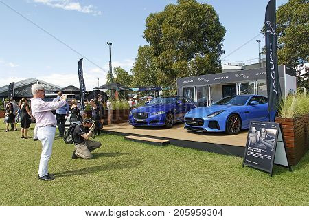 Melbourne, Australia: March 25, 2017: High performance Jaguar cars on display at Melbourne's Albert Park. Car enthusiasts look admiringly at the super car and take photographs