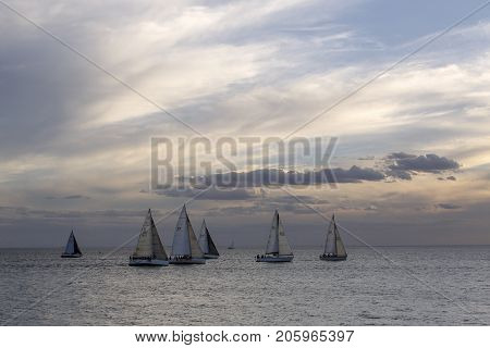 St Kilda, Australia: March 15, 2017: Sail boats racing on the ocean off St Kilda Pier where they are harbored.