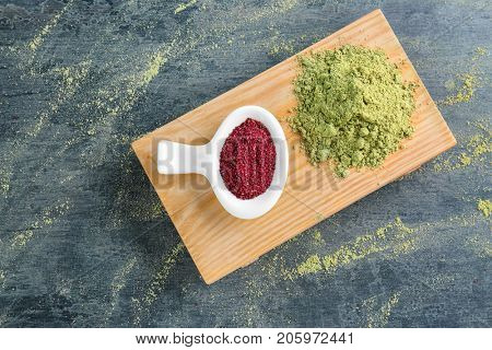 Maqui berry and hemp protein powders on color background