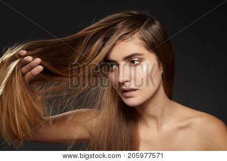 Beautiful fashion woman with long brown hair. Beauty treatment. Straight Hairstyle. Hair problem. Collagen repair keratin