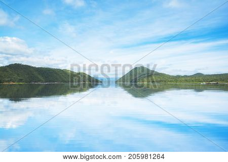 Beautiful sky and mountain with water reflection from Srinakarin Kanchanaburi Thailand. Nature background.