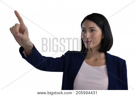 Businesswoman touching invisible screen against white background