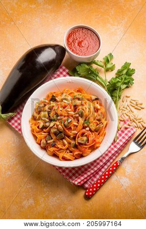 tagliatelle with eggplant tomato sauce and pinenuts