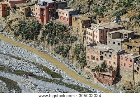 Population At The Foot Of The High Atlas Mountains In The Valley Of Ourika And River Of The Same Nam