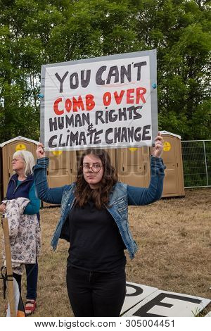 Shannon, Ireland, June. 5, 2019: A Young Lady Protesting Against The Donald Trump Visit With Signs A