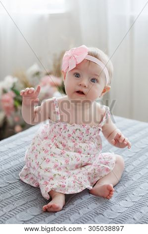 Adorable Baby Boy In White Sunny Bedroom Plays Alone On The Bed.charming Beautiful Lovely Small Fema
