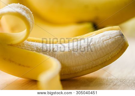 Banana Peel / Close Up Od Fresh Ripe A Banana Fruit Peeled On Wooden Board