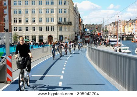 Copenhagen, Denmark: May 12, 2019 - Blond Girl On Bike Drive On Inderhavnsbroen Bridge In Copenhagen