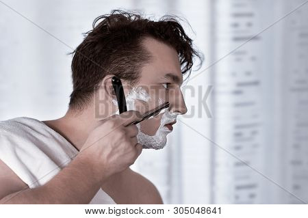 Young Handsome Caucasian Man With Electronic Watch On Wrist Shaves With Straight Razor (vintage Styl