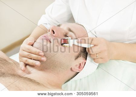 Young Man On The Procedure Of Rejuvenation And Cleansing Of The Skin Of The Modern Medical Instrumen