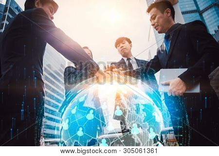 Close Up Of Businessmen Shaking Hands. Global Network And A World Map In The Foreground. Block Chain