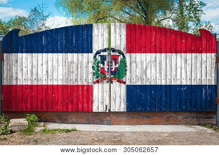 Close-up Of The National Flag Of Dominicana On A Wooden Gate At The Entrance To The Closed Territory