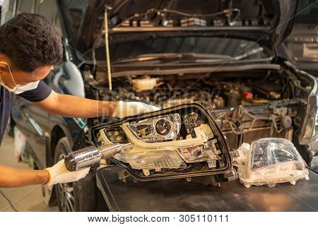 Car Mechanic, Doing Cleaning, The Headlight Of The Car, Installation And Turning Headlight Of Modern
