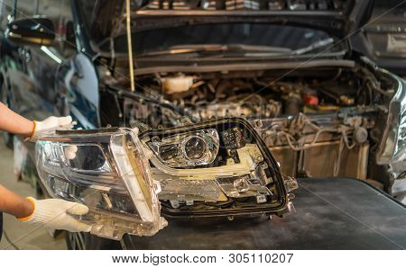 Car Mechanic, Doing Cleaning, The Headlight Of The Car, Installation And Turning Headlight Of Modern