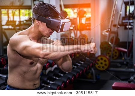 Exercise In Gym Concept.asian Men Have Muscle Playing Vr       (virtual Reality) Machine Standing In