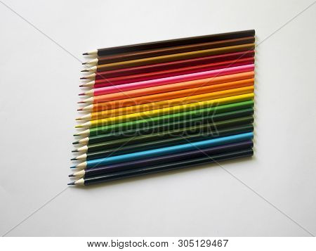 ..multicolored Pencils Lie On A White Table.
