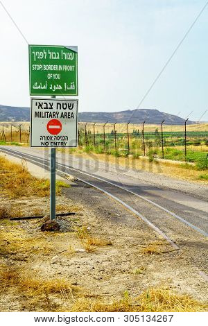 Gesher, Israel - June 04, 2019: The Jordan River Valley, And Border Warning Signs, Near The Border B