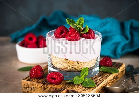 No Baked Cheesecake With Raspberry In Glass Jar. Healthy Dessert.