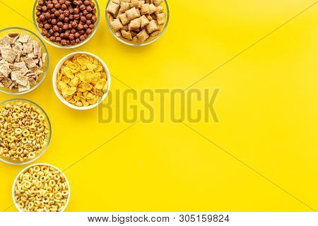 Cereals, Oatflakes And Cornflakes For Healthy Breakfast On Yellow Background Top View Mock Up