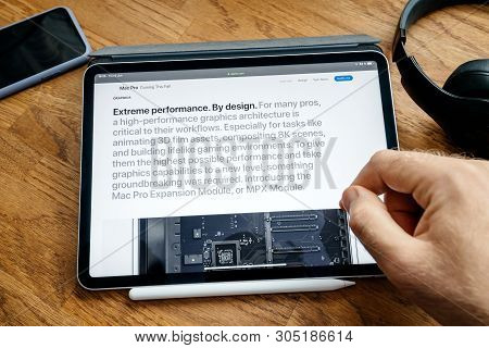 Paris, France - Jun 6, 2019: Man Reading On Apple Ipad Pro Tablet About Latest Announcement Of At De