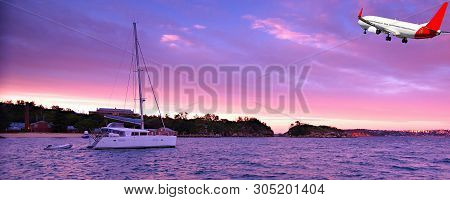 Australian Colourful Cirrus Cloudy Sunrise Seascape With An Anchored Sailboat And Airborne Passenger