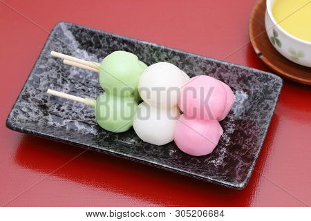 Japanese Traditional Confectionery Sanshoku Dango On Red Background