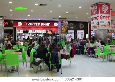Russia, Novosibirsk, January 7, 2019: Visitors Girls Burger King Eat At A Fast Food Table Waiting Fo