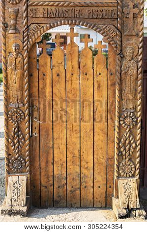 Prahova, Romania - March 30, 2019: Carved Wood Door Entrance To Pisiota Monastery Courtyard Located 