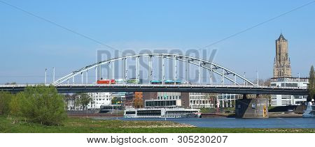 Arnhem, Netherlands - April 18, 2019: View At The Old Bridge, Cruise Ships, Church And River In Arnh
