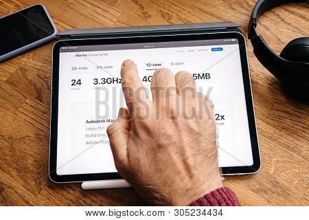 Paris, France - Jun 6, 2019: Man Hand Press On Display On Apple Ipad Pro Tablet About Latest Announc