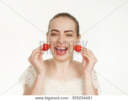 Beautiful Girl Makes Makeup Strawberry Berries On A White Background