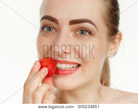 Beautiful Girl Makes Makeup Strawberry Berries On A White Background