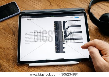 Paris, France - Jun 6, 2019: Man Reading On Apple Ipad Pro Tablet About Latest Announcement Of At De