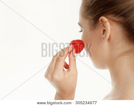 Beautiful Girl Makes Makeup Strawberry Berries On A White Background