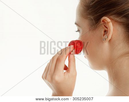 Beautiful Girl Makes Makeup Strawberry Berries On A White Background