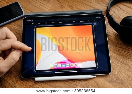 Paris, France - Jun 6, 2019: Man Reading On Apple Ipad Pro Tablet About Latest Announcement Of At Ap