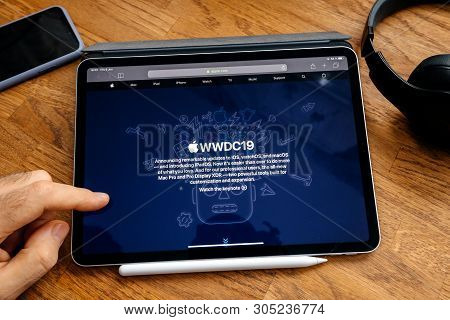 Paris, France - Jun 6, 2019: Man Reading On Apple Ipad Pro Tablet About Latest Announcement Of At Ap
