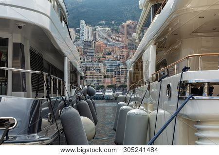 La Condamine, Monaco - June 04, 2019: Yachts Docked At Port Hercules In La Condamine Harbour. Citysc