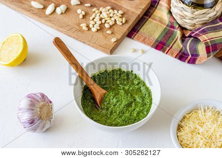Pesto Sauce And Ingedients On A White Background. Italian Cuisine. Vegetarian Food. The Diet