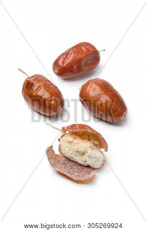 Dried fresh organic fruit of the Oleaster, Silver berry or russian olive and a peeled one close up isolated on white background