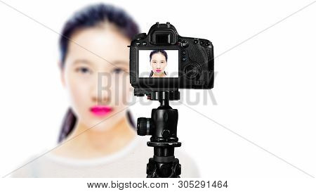Focus On Live View On Camera On Tripod, Teenage Girl   With Blurred Scene In Background. Teenage Vlo