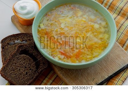 Traditional Soup Of Russia Shchi Served With Sour Cream As Garnish And Rye Bread