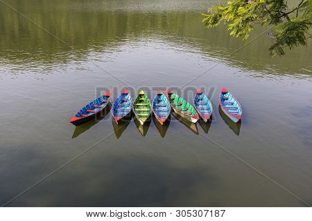 Colorful Small Boats On Phewa Lake In Pokhara, Nepal Multi Colored Timber Rowing Boats On Fewa Lake 