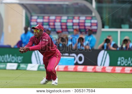 NOTTINGHAM, ENGLAND. 06 JUNE 2019: Sheldon Cottrell of West Indies takes a catch to dismiss Pat Cummins of Australia  during the Australia against West Indies, ICC Cricket World Cup match