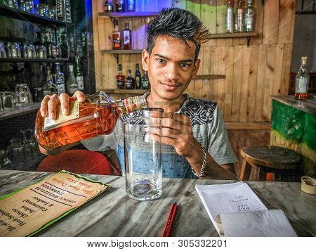 Colva,goa/india-january 1:krishna The Bartender Pours A Shot Of Whiskey At A Small Beach Restaurant,