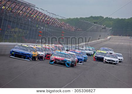 June 02, 2019 - Long Pond, Pennsylvania, USA: Kyle Busch (18) leads the field down the front stretch during the Pocono 400 at Pocono Raceway in Long Pond, Pennsylvania.