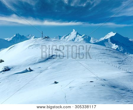 Cross On Winter Mountain Shneeberg Top And View Alps Peaks Behind, Hochkoenig Region, Austria