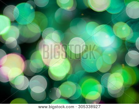 Greensand White Glowing Round Blurred Lights On A Black Background Abstract