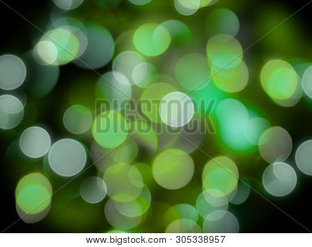 Greensand White Glowing Round Blurred Lights On A Black Background Abstract