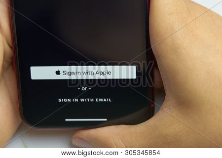 Bishkek, Kyrgyzstan - June 6, 2019: Sign In With Apple Button For Your Privacy. Man Holds A Smartpho